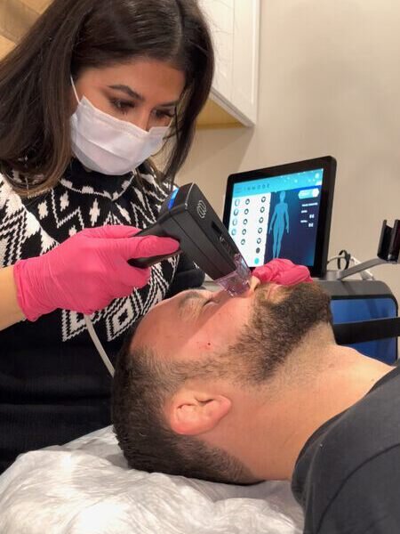 Aesthetic professional administering a Morpheus8 treatment